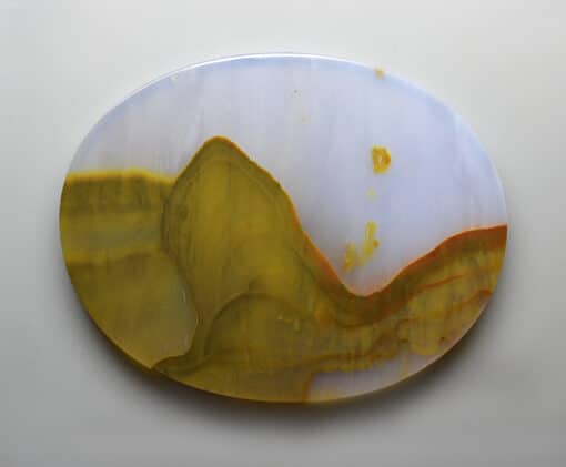 A yellow and white agate plate on a white surface.