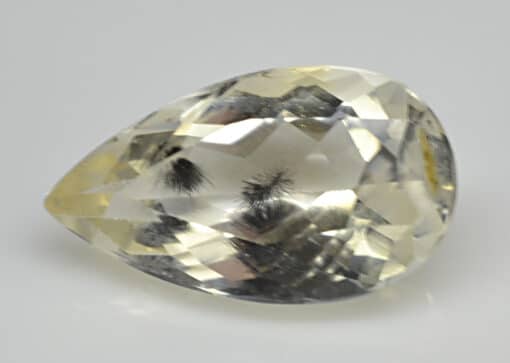 A pear shaped yellow topaz gemstone.