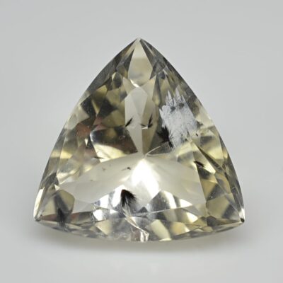 A triangular shaped yellow sapphire on a white background.