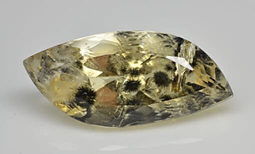 A yellow sapphire on a white surface.