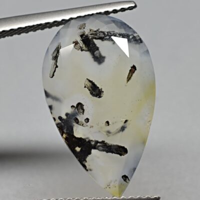 A pear shaped agate stone with black streaks.