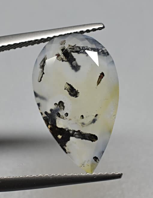A pear shaped agate stone with black streaks.