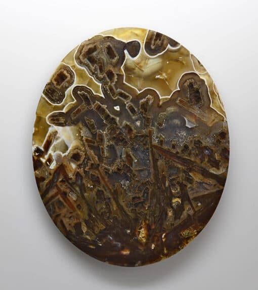 A circular piece of agate on a white surface.