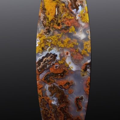 An oval piece of agate with orange and brown colors.