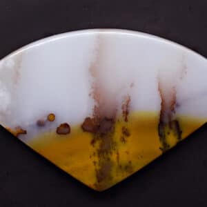 A piece of agate with a yellow and brown pattern.