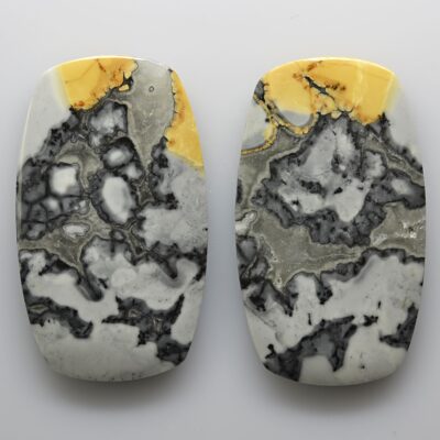 Two pieces of marble with yellow and white designs.