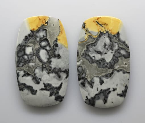 Two pieces of marble with yellow and white designs.