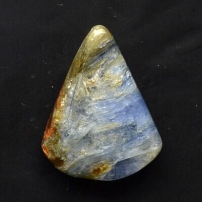 A piece of blue and yellow quartz on a black surface.