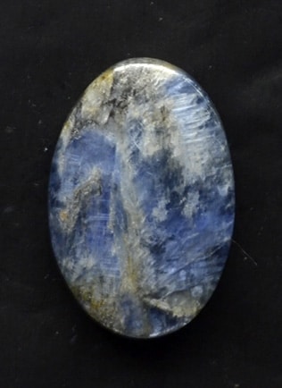 A blue stone on a black surface.