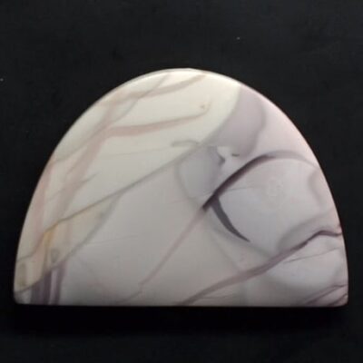 A white and pink marble pendant on a black surface.