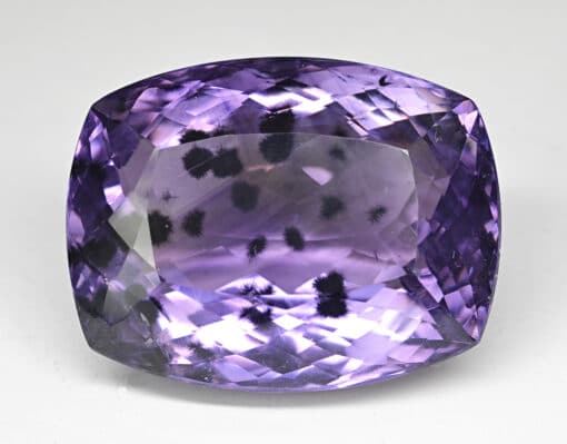 A cushion cut purple amethyst gemstone.
