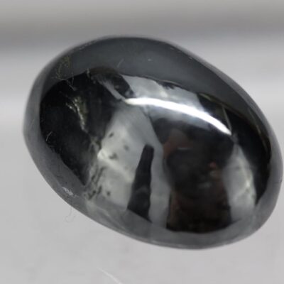 A black diamond on a white surface.