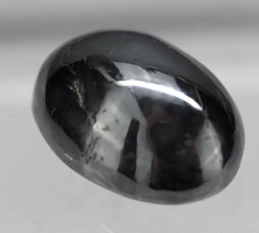 A black diamond on a white surface.