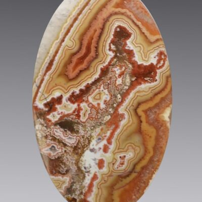 A red and brown agate oval cabochon.