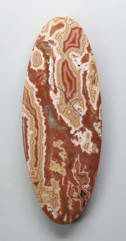 An oval piece of agate on a white background.