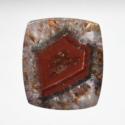 A square piece of red apatite on a white background.