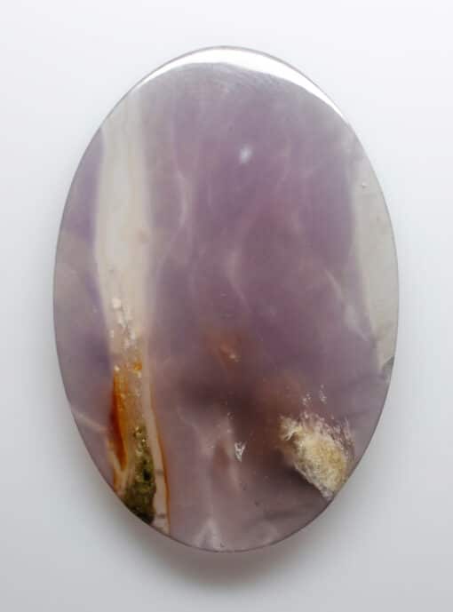 A purple agate on a white surface.