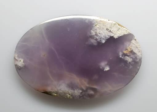A purple agate on a white surface.