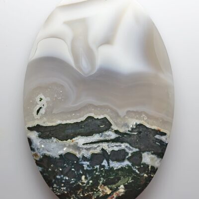 A white and black agate on a white surface.