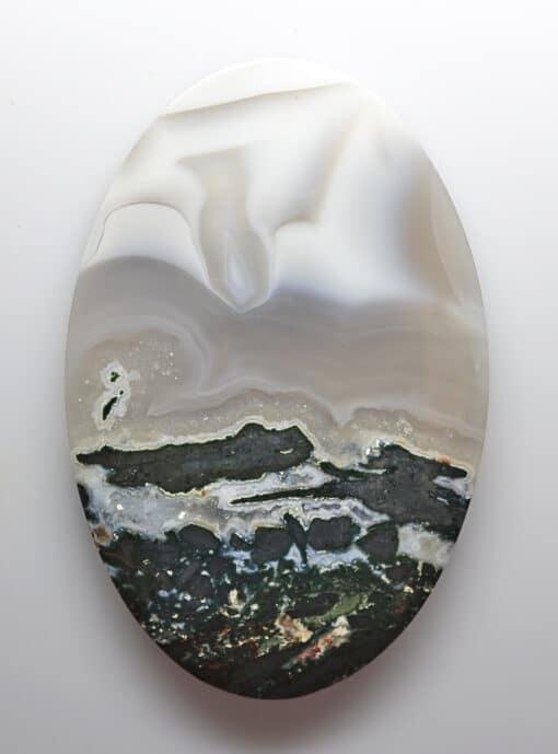 A white and black agate on a white surface.