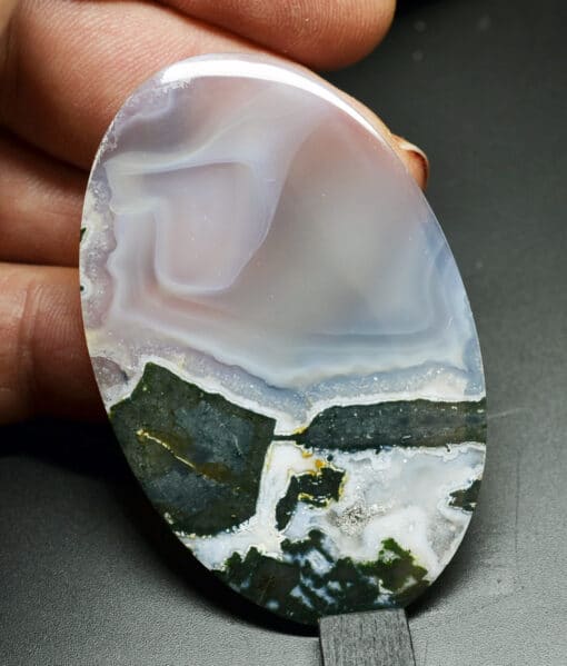 A white and black agate plate on a white surface.