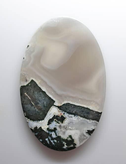 A white and black agate plate on a white surface.