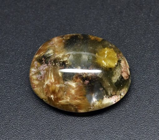 An oval shaped stone with a yellow flower on it.