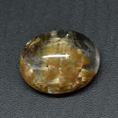 A yellow and brown stone on a black surface.