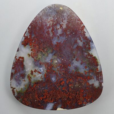 A triangular piece of red and brown agate.