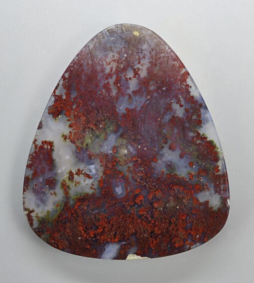 A triangular piece of red and brown agate.