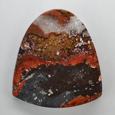 A piece of agate with red and brown colors.