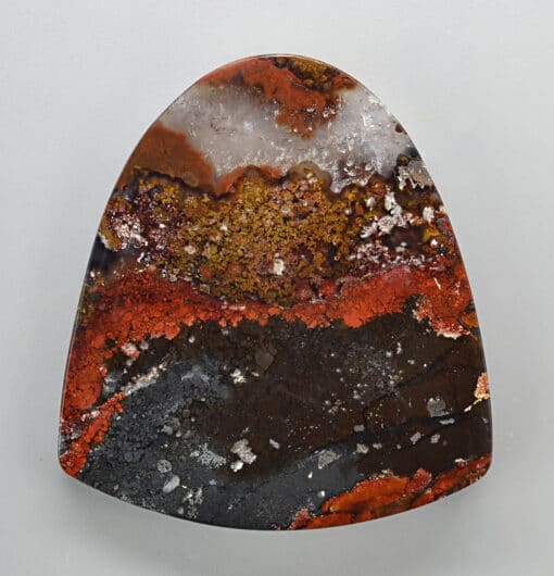 A piece of agate with red and brown colors.