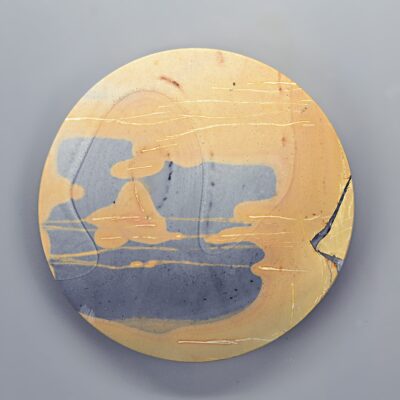 A ceramic plate with a yellow and blue design.