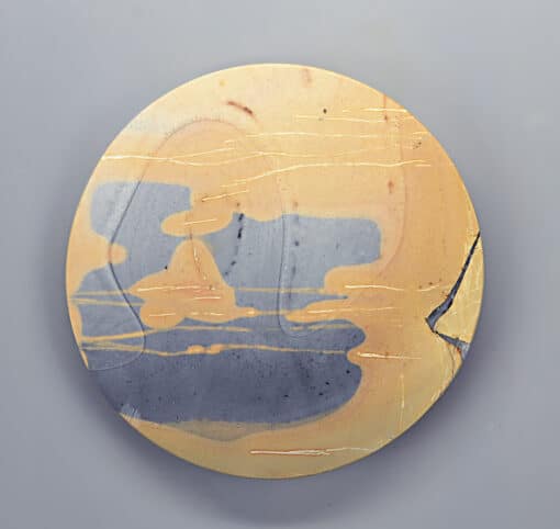 A ceramic plate with a yellow and blue design.