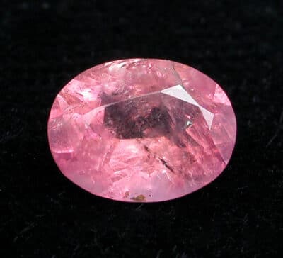 A pink sapphire on a black background.