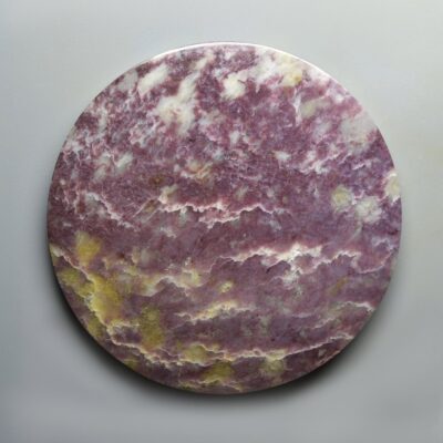 A purple marble plate on a white surface.