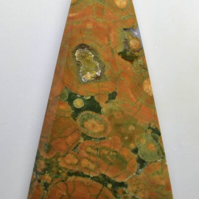 A cone shaped piece of orange and green marble.
