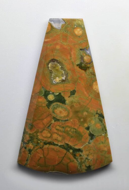 A cone shaped piece of orange and green marble.