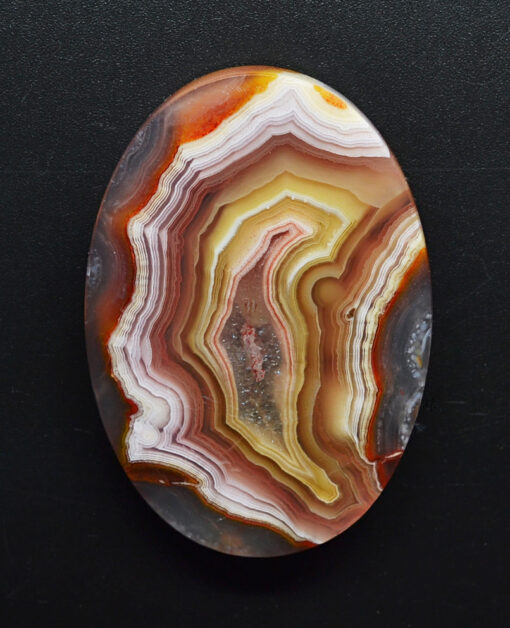 A piece of agate on a black surface.