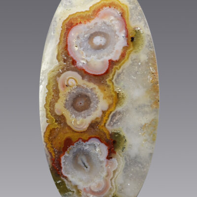 An Stalactitic agate 28.01 ct Oval Cabochon 36.50 x 17.50 x 5.50 mm max3587b shaped with a flower on it.