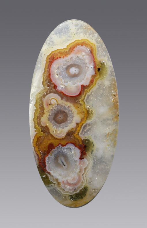 An Stalactitic agate 28.01 ct Oval Cabochon 36.50 x 17.50 x 5.50 mm max3587b shaped with a flower on it.