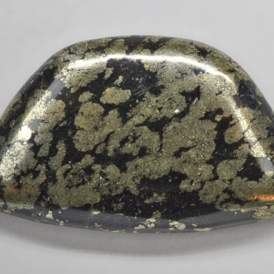 A black and gold shaped stone.