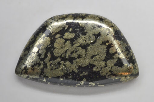 A black and gold shaped stone.