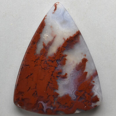 A triangular piece of red and white agate.