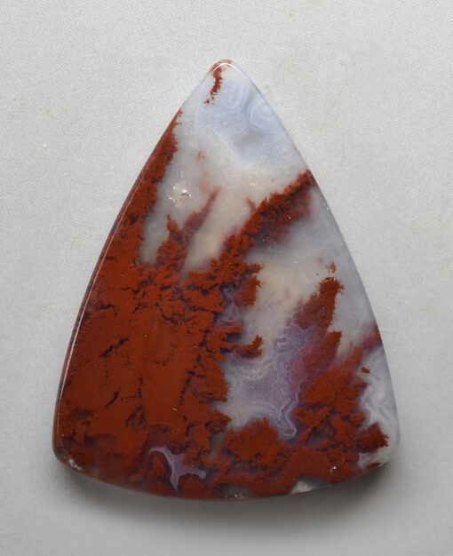 A triangular piece of red and white agate.