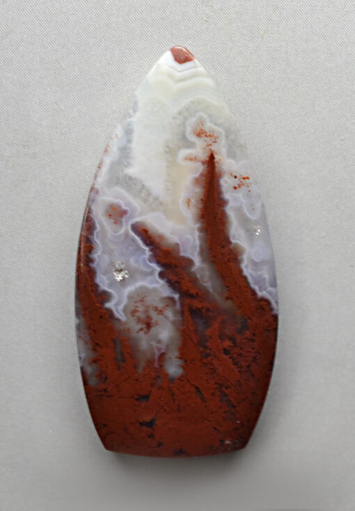 A piece of agate with a red and white pattern.