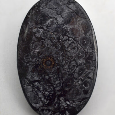 A black stone with a black pattern on it.