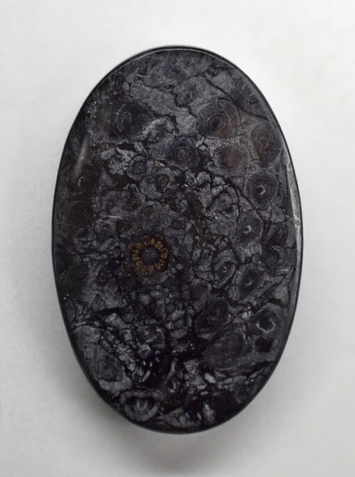 A black stone with a black pattern on it.