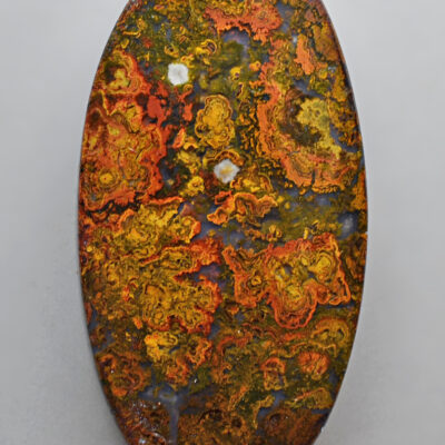 An oval shaped piece of yellow and orange colored jasper.