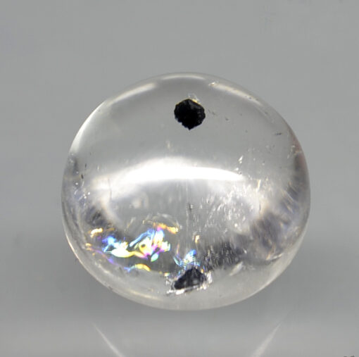A clear sphere with black dots on it.